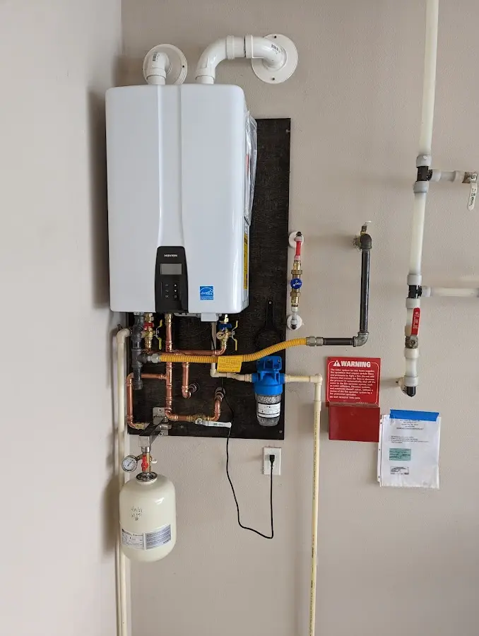 Professional plumber installing copper piping in a Hiawatha home